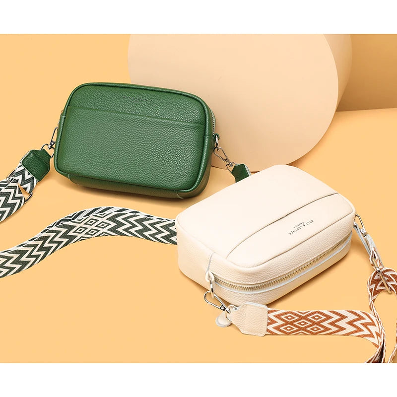 Two crossbody bags, one green and one beige, on a beige background.