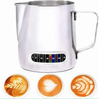 Stainless steel milk frothing pitcher with temperature gauge and latte art examples.