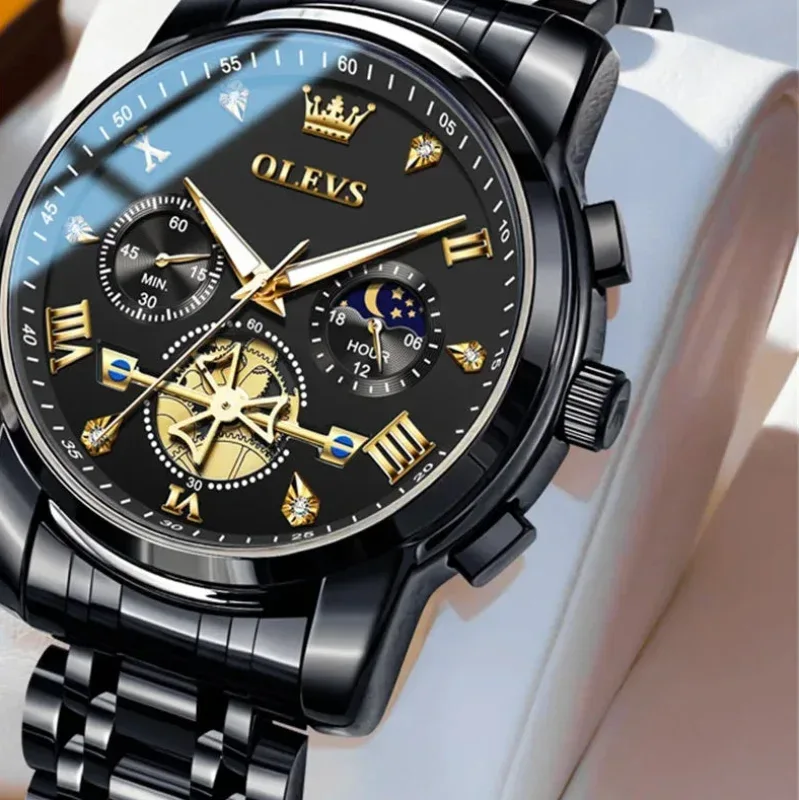 Black and gold OLEVS watch with detailed face on a white background