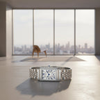 Silver watch with rectangular face on a white background, featuring the brand 'SANDA'.