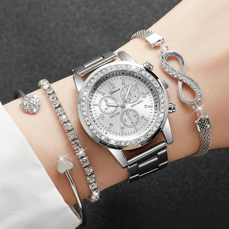 Silver watch with diamond-studded face and multiple bracelets on a wrist against a dark background