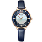 Curren watch with blue strap and rose gold case on white background