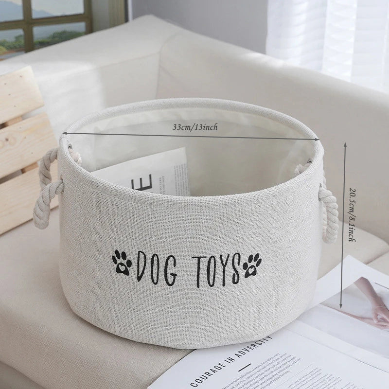 Beige storage basket labeled 'DOG TOYS' with dimensions on a white surface.