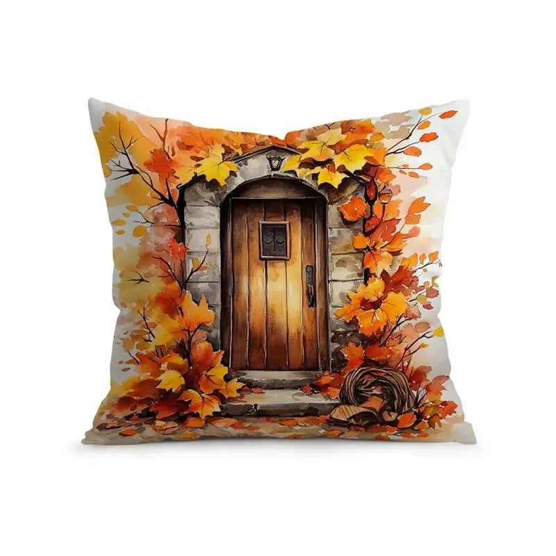 A square decorative throw pillow featuring a printed autumn scene of a rustic wooden door framed by orange and yellow fall leaves, shown on a plain white background.