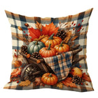 A square decorative throw pillow featuring an autumn-themed print with pumpkins, pinecones, maple leaves, and berries in a wooden wheelbarrow, set against a blue, beige, and brown plaid background. The pillow is shown on a plain white background, with partial black text at the top reading 'This product is'.