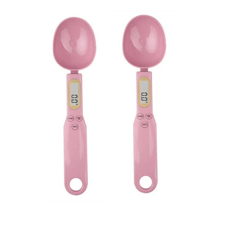 Two pink digital measuring spoons on a white background