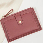 Pink purple wallet with a gold zipper on a light background