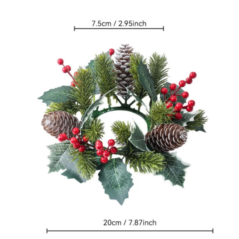 An artificial Christmas wreath with pine branches, green holly leaves, brown pinecones, and red berries, shown with measurement lines indicating a width of 20cm (7.87 inches) and a height of 7.