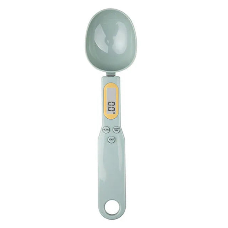 Digital measuring spoon with a light green handle and gray head on a white background