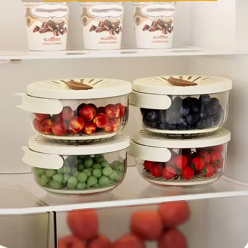 Stackable fruit storage containers with lids on a refrigerator shelf.