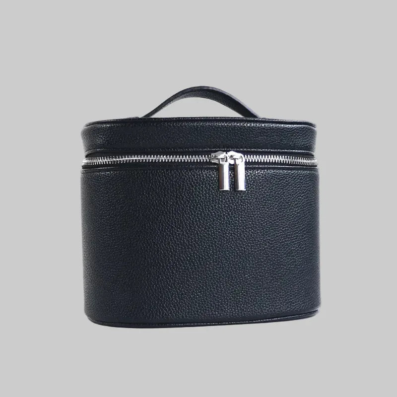 Black leather travel case with a silver zipper on a white background