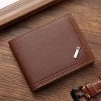 Brown leather wallet with a strap on a wooden surface