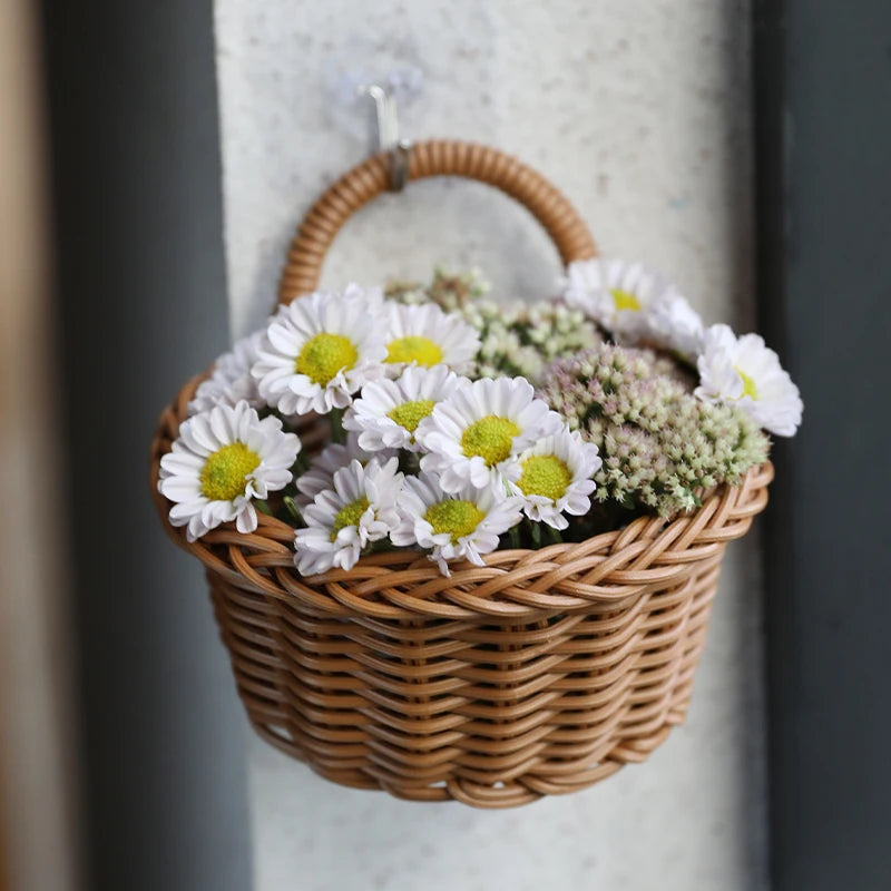Wicker basket with white flowers hanging on a wall