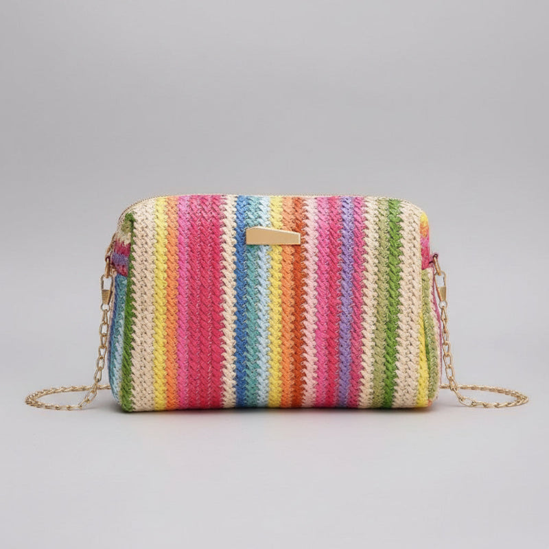 Colorful striped handbag with a chain strap on a beige background