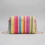 Colorful striped handbag with a chain strap on a beige background