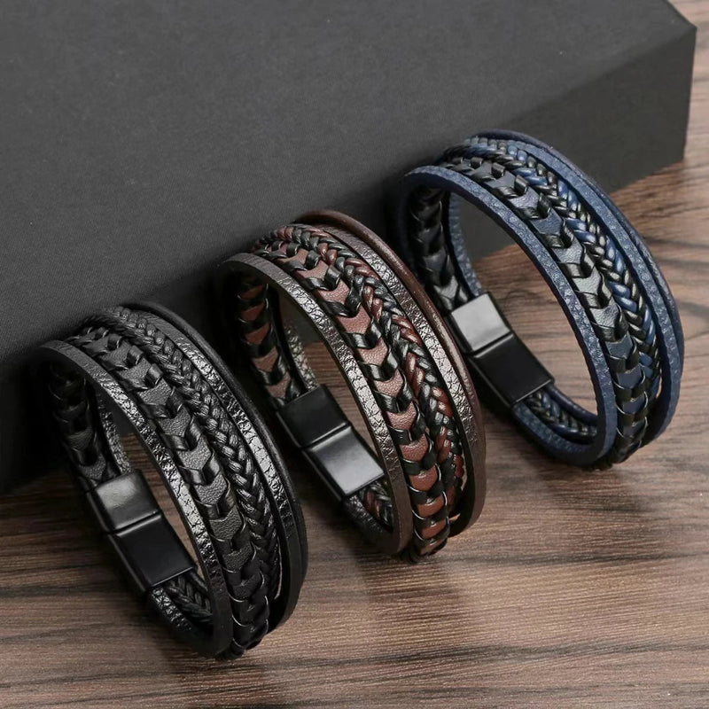 Three braided leather bracelets on a wooden surface with a dark gray background