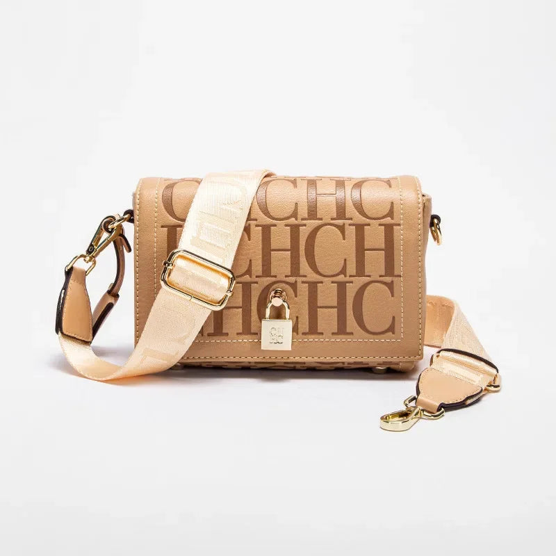 Beige handbag with gold accents on a white background