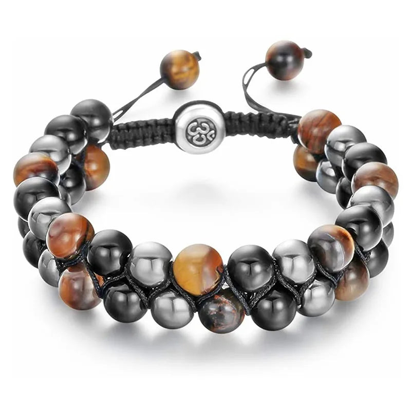 A beaded stretch bracelet featuring glossy black, metallic silver, and brown tiger's eye beads, secured with a black cord and a silver-toned central charm.