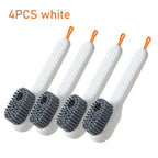 Four white scrub brushes with orange ends on a white background