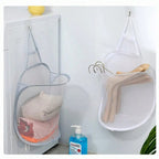 Mesh laundry bags hanging on a hook with cleaning supplies on a white surface.