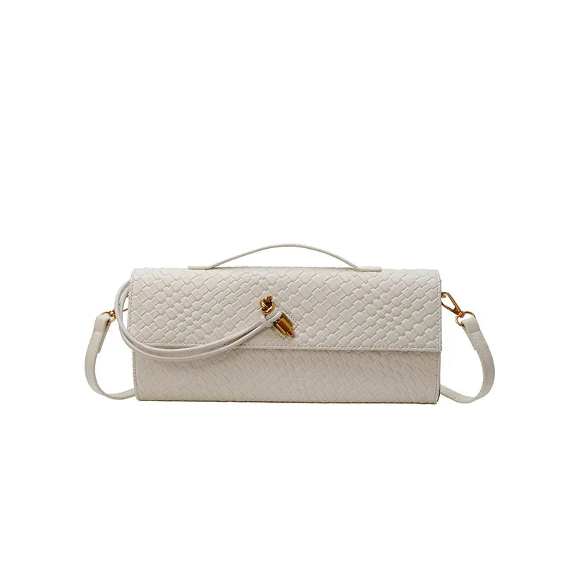 White textured handbag with a strap on a white background