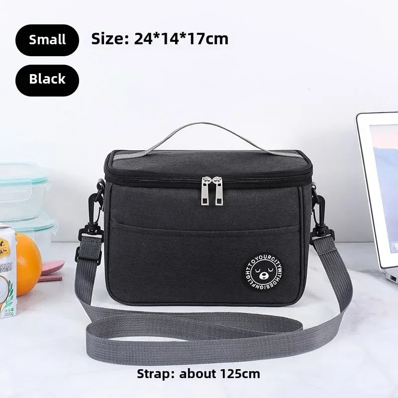 Black crossbody bag with strap on a white surface, size and strap length information displayed.