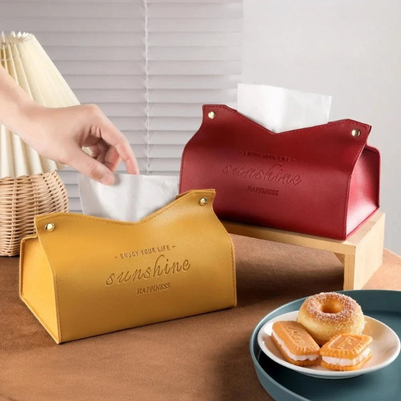 Yellow and red tissue holders with 'sunshine' text on a table with a plate of pastries.