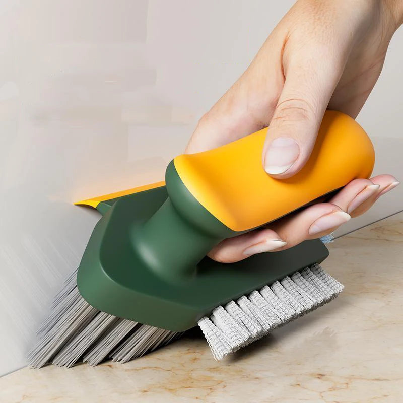 Hand using a green and yellow brush to scrub a surface