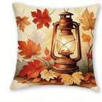 Square decorative throw pillow featuring an autumn-themed print with a glowing vintage lantern and scattered red, orange, and beige leaves on a cream background.