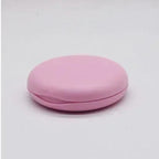 Pink round compact on a light gray background