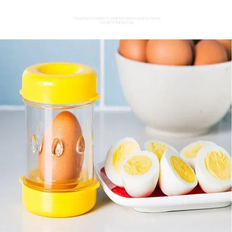 Clear container with a yellow lid holding an egg, next to a plate of hard-boiled eggs.