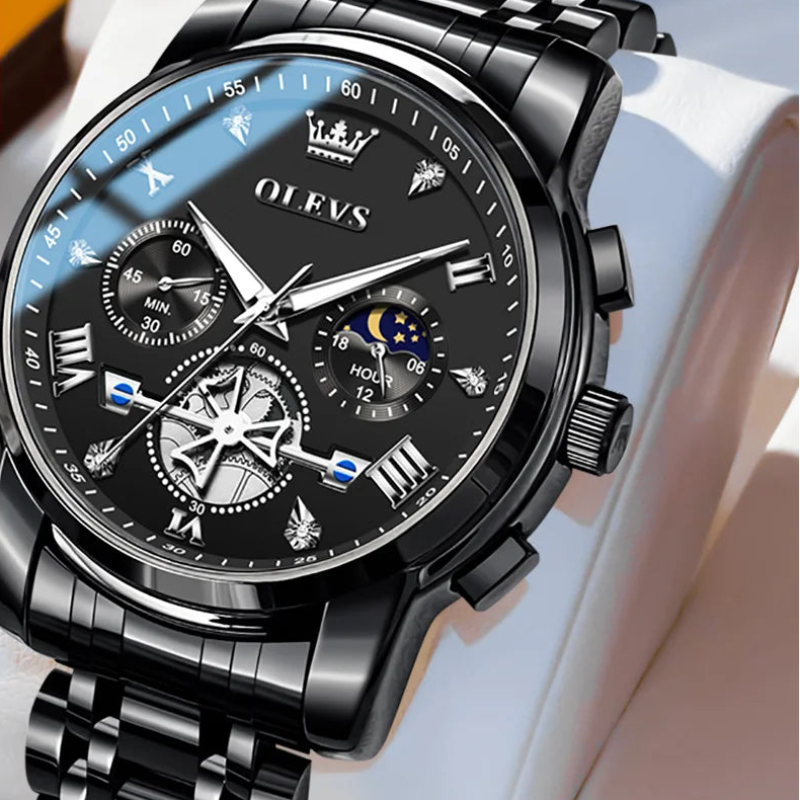 Black OLEVS watch with detailed face and metal strap on a white background