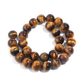 A strand of polished round tiger's eye beads, arranged in a double loop on a clean white background.