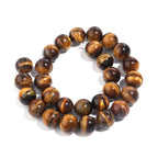 A strand of polished round tiger's eye beads, arranged in a double loop on a clean white background.