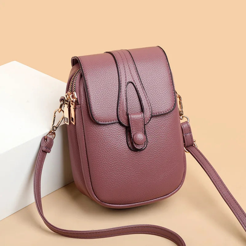Purple handbag with a strap on a beige background