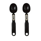 Two black digital measuring spoons on a white background