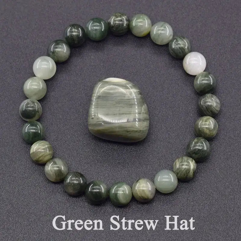 Beaded bracelet with a central stone on a gray background, labeled 'Green Strew Hat'.