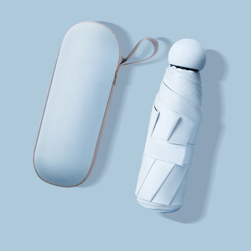 A light blue compact umbrella and its matching oval carrying case, shown on a pale blue background.