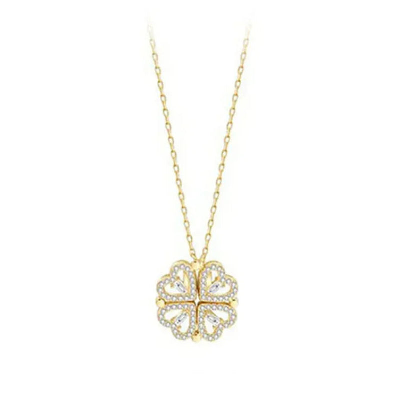 Gold necklace with a clover-shaped pendant on a white background