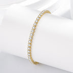 Gold bracelet with clear stones on a white surface