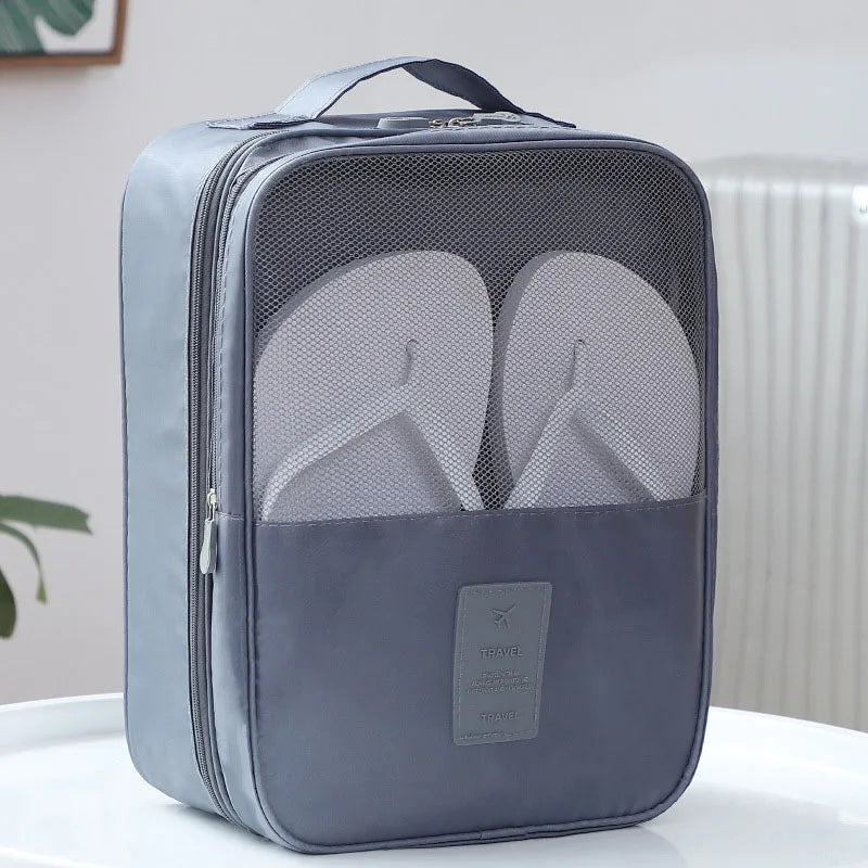 Gray shoe organizer with flip-flops inside on a white surface