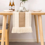 Dining table with a woven runner and ceramic items on a neutral background