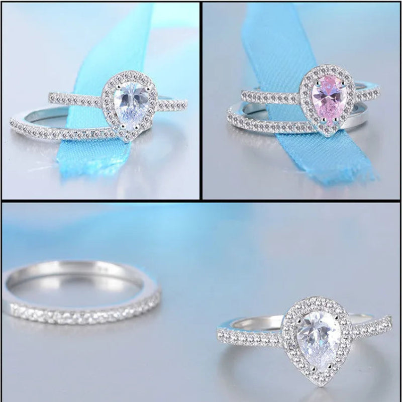 Set of silver rings with heart-shaped gemstones on a light blue background