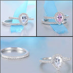Set of silver rings with heart-shaped gemstones on a light blue background