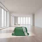Green leather crossbody bag with a patterned strap on a white background