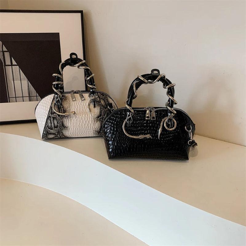 Two handbags, one black and one white with black accents, on a light surface.