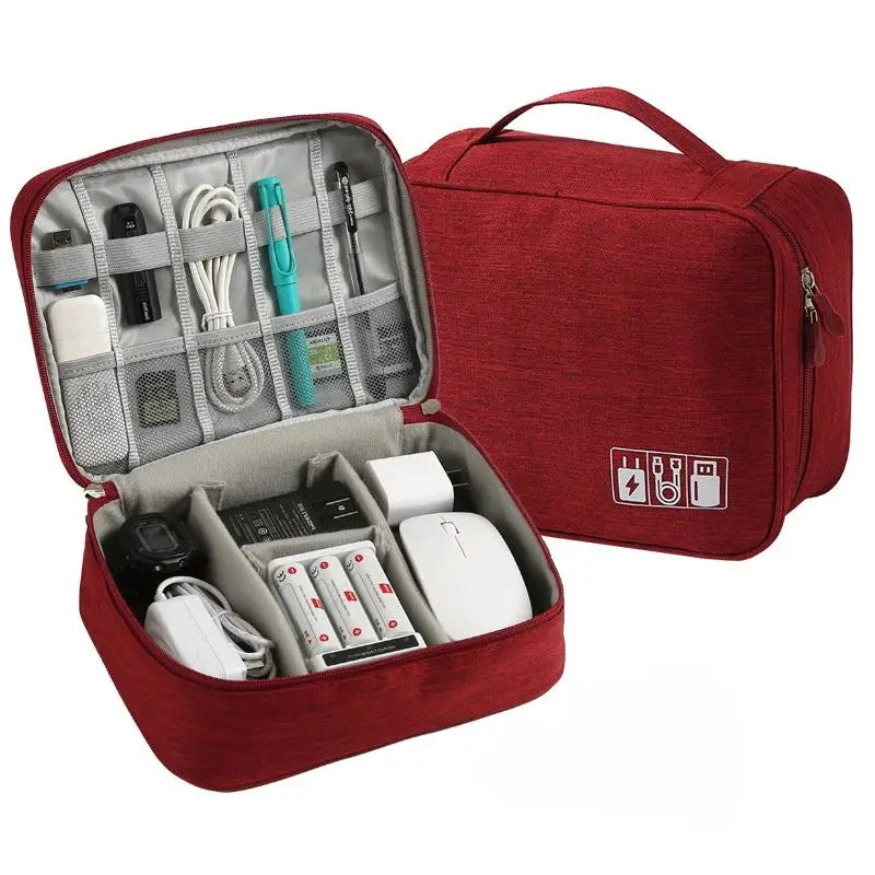 Red travel organizer with compartments filled with electronic devices on a white background
