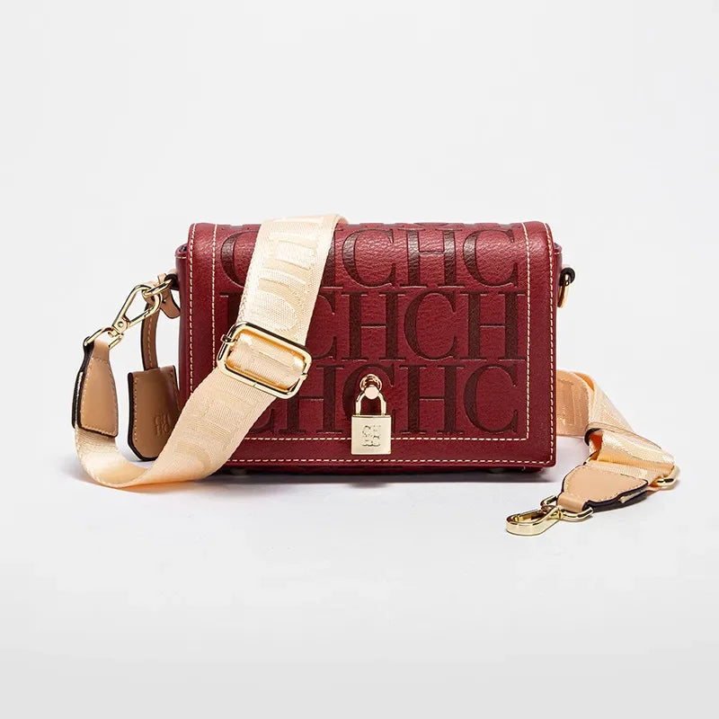 Red handbag with gold accents on a light gray background