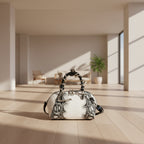 White handbag with black snake print and braided handle on a white background