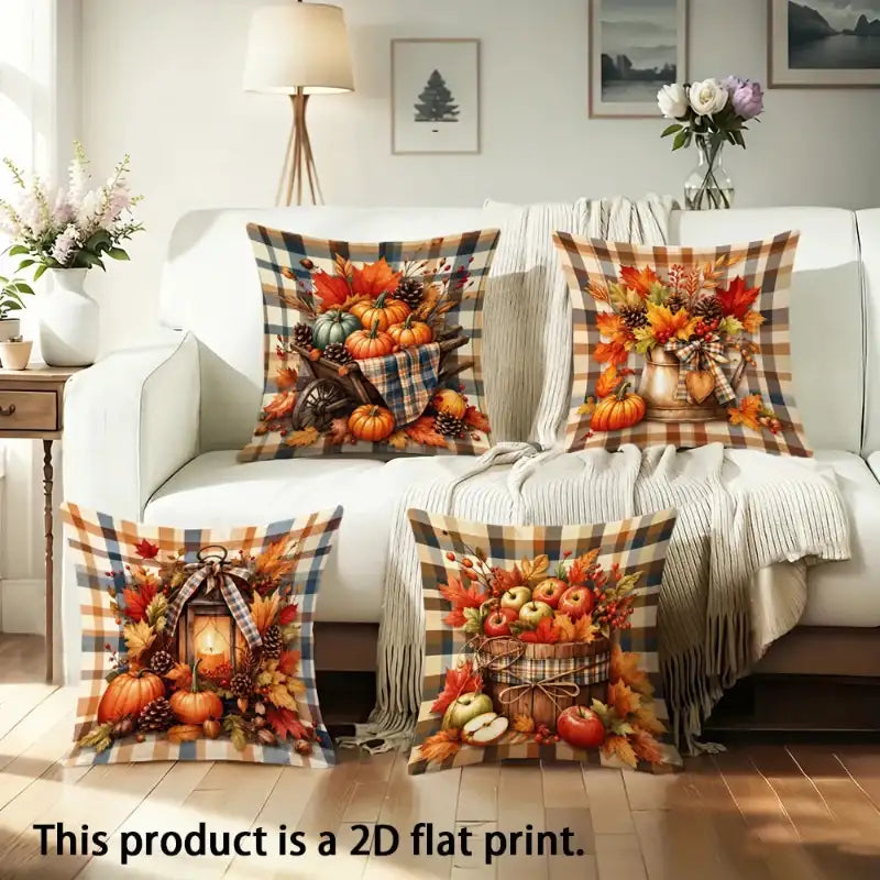 Four decorative throw pillows with autumn harvest prints are arranged on a white sofa in a living room setting, with a text overlay at the bottom stating 'This product is a 2D flat print.'.